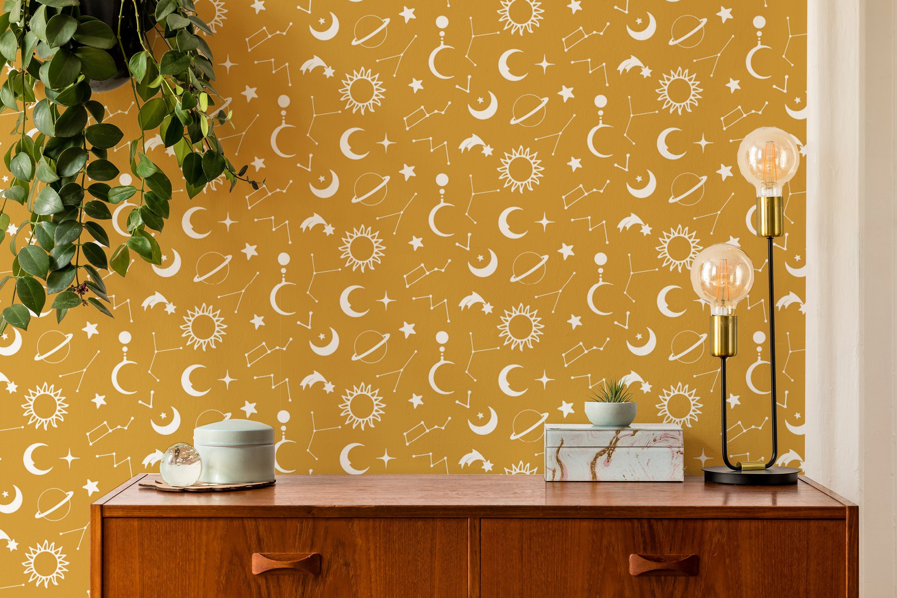 Celestial yellow wallpaper with moons and stars
